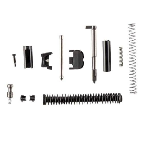 A disassembled slide parts kit for Glock is displayed, containing a recoil spring, firing pin, channel liner, extractor, spring-loaded bearing, depressor plunger spring, and slide cover plate. Designed for Gen 3 Glock 17, 19, and 26 slides, as well as P80 and PSA Dagger frames